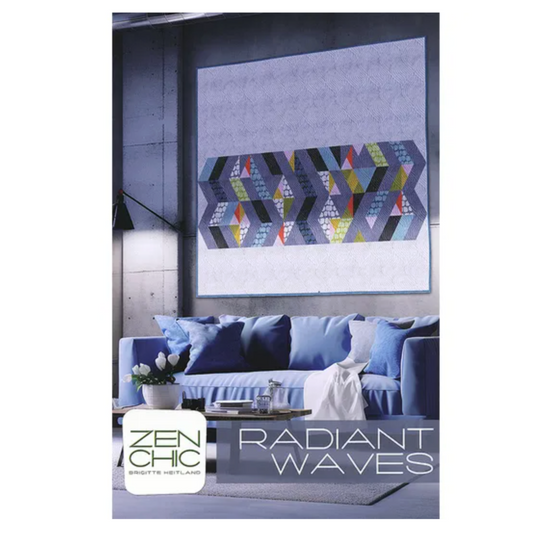Living room with a blue sofa and abstract wall art, featuring 'Zen Chic' brand.