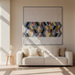Living room with a blue sofa and abstract wall art, featuring 'Zen Chic' brand.