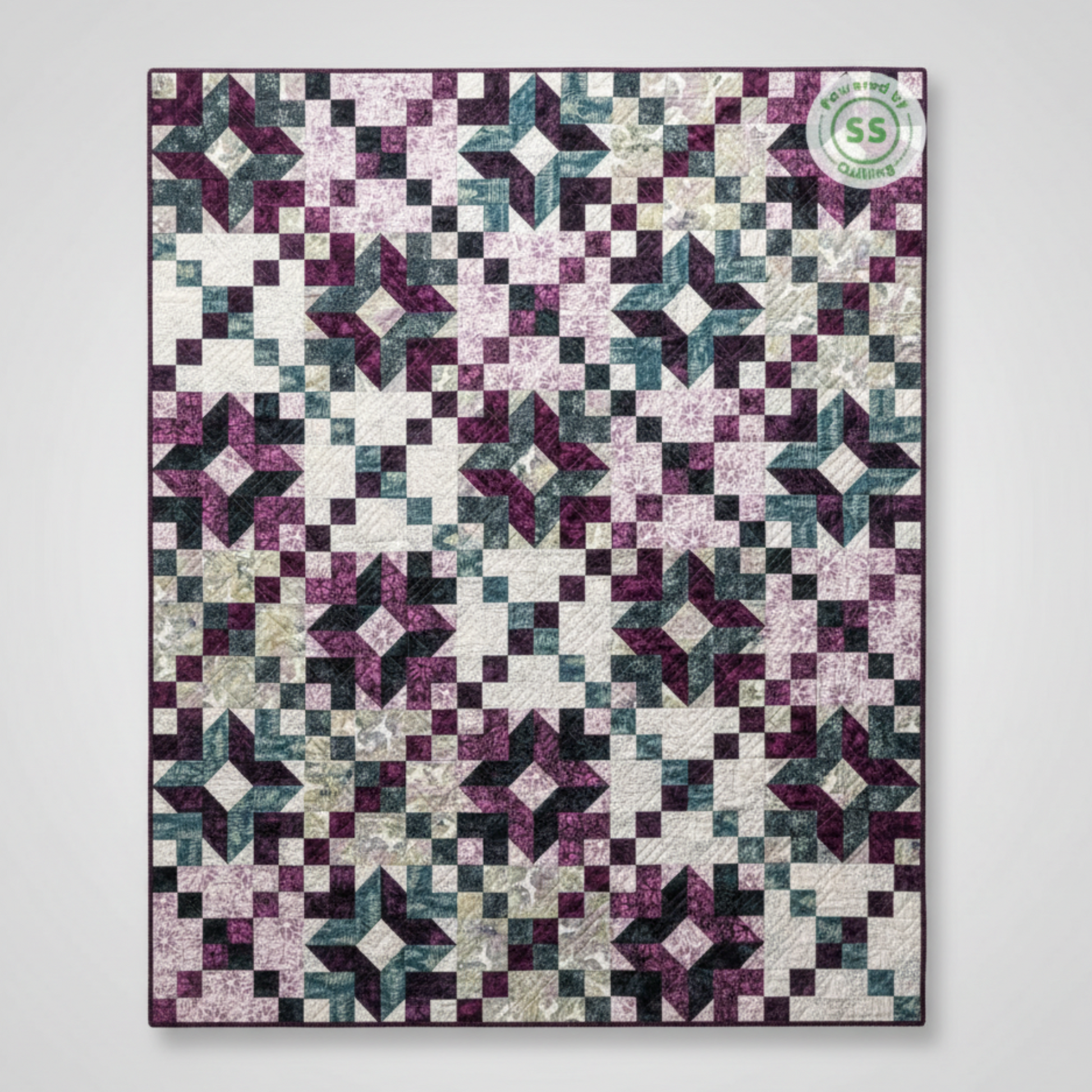 Quilt with star pattern in purple, black, and white on a white background
