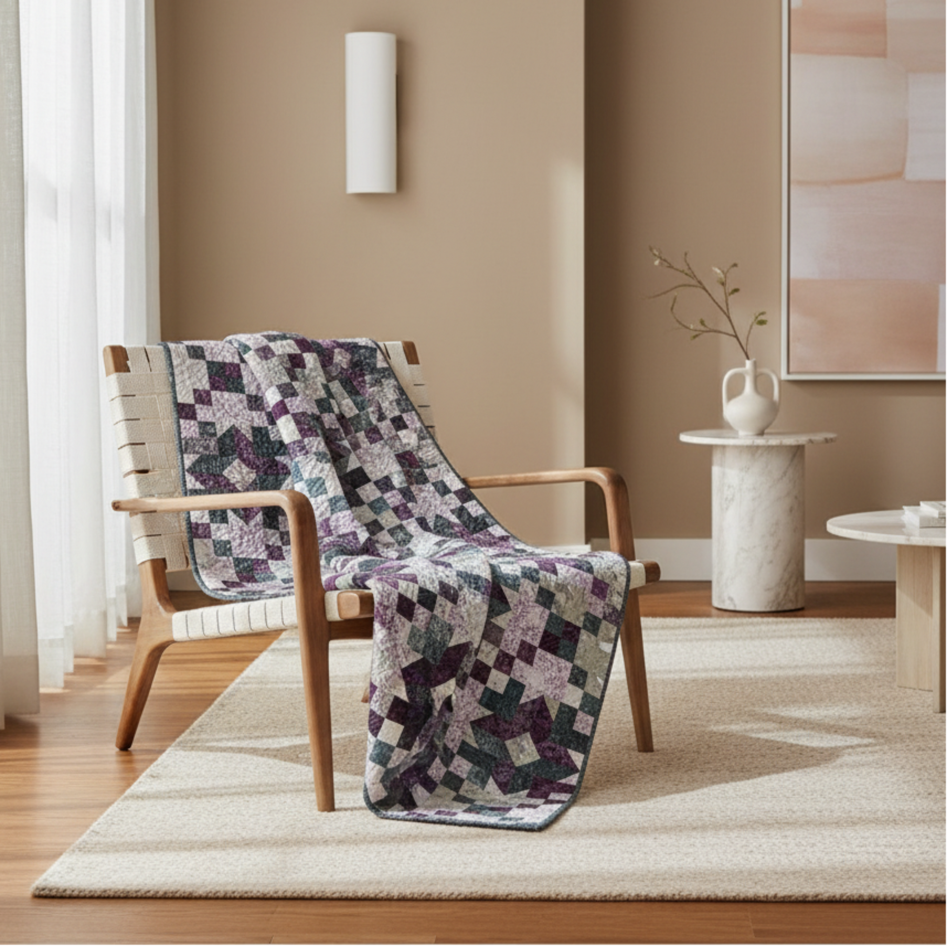 Quilt draped over a wooden chair in a room with a neutral color scheme.