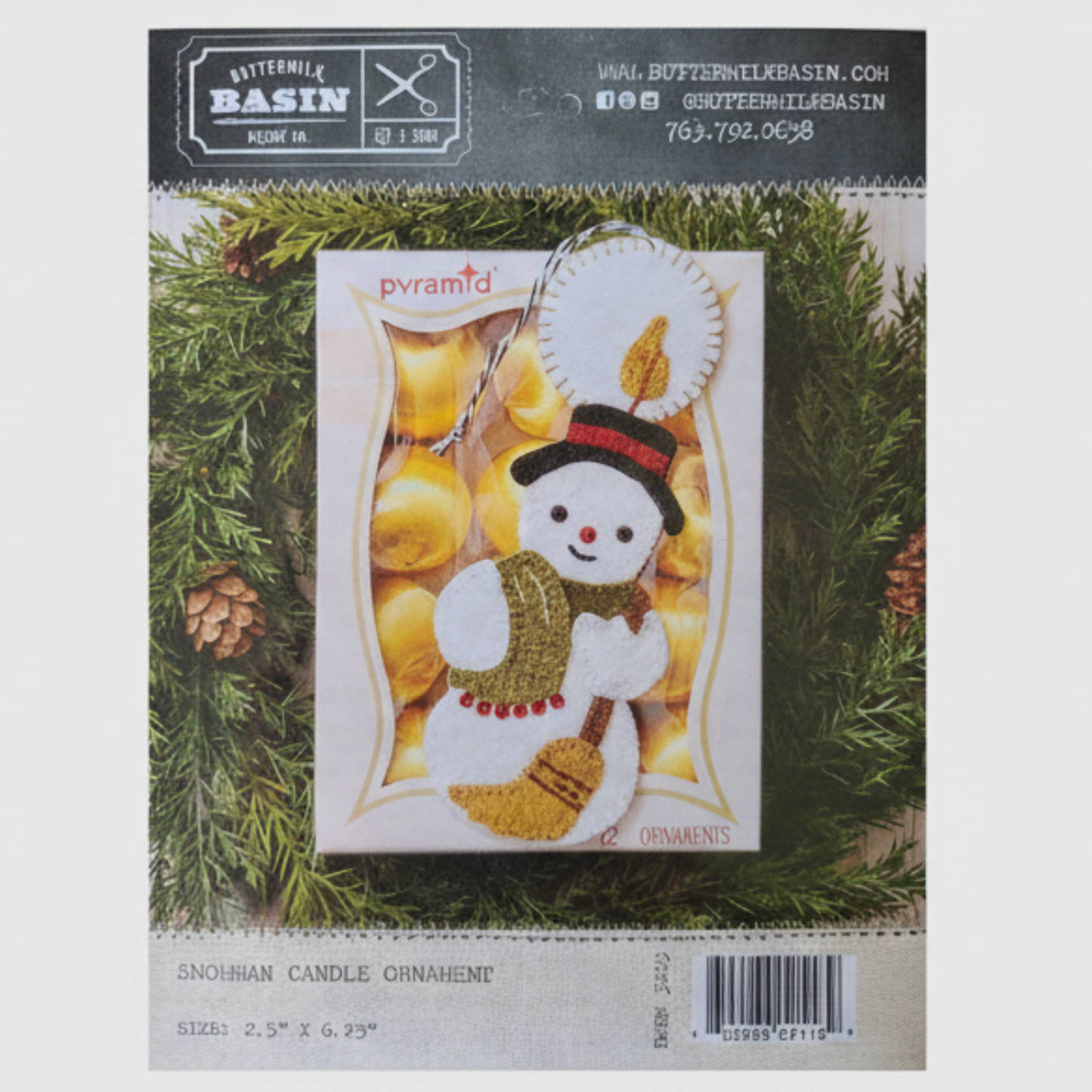 Snowman candle ornament packaging on a green leaf background