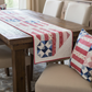Star Spangled Table Runner pattern packaging with quilt design on grass background