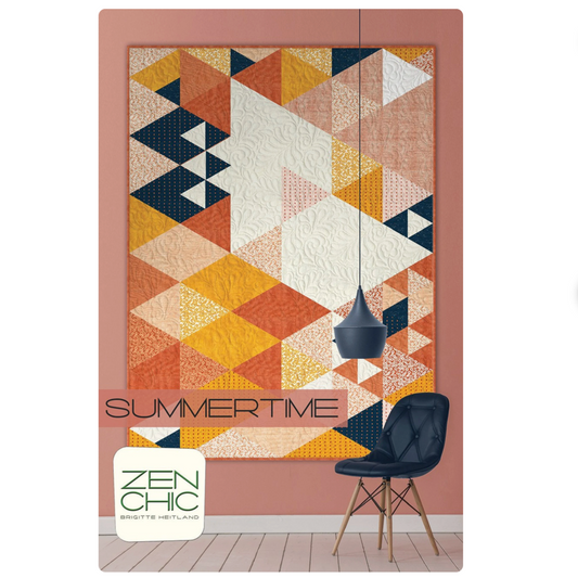 Geometric patterned quilt with 'Summertime' text and Zen Chic logo on a pink wall.