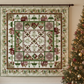 Quilt with geometric pattern displayed on a wall next to a decorated Christmas tree.