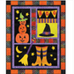 Halloween-themed quilt with pumpkins, witch hat, boots, and 'BOO' banner.