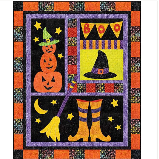 Halloween-themed quilt with pumpkins, witch hat, boots, and 'BOO' banner.