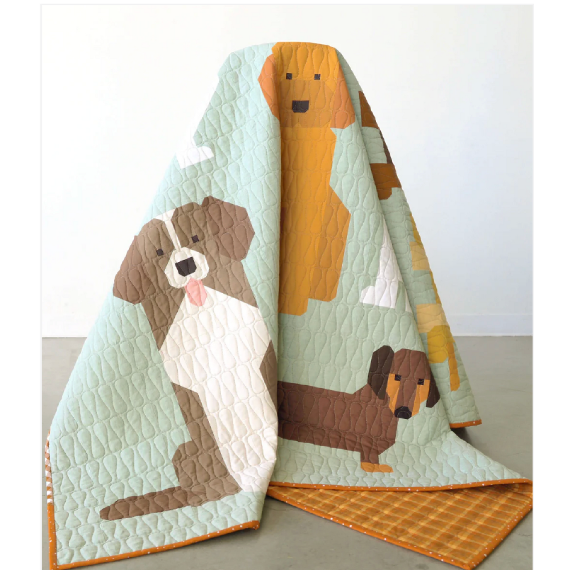 Quilt with dog illustrations on a light background