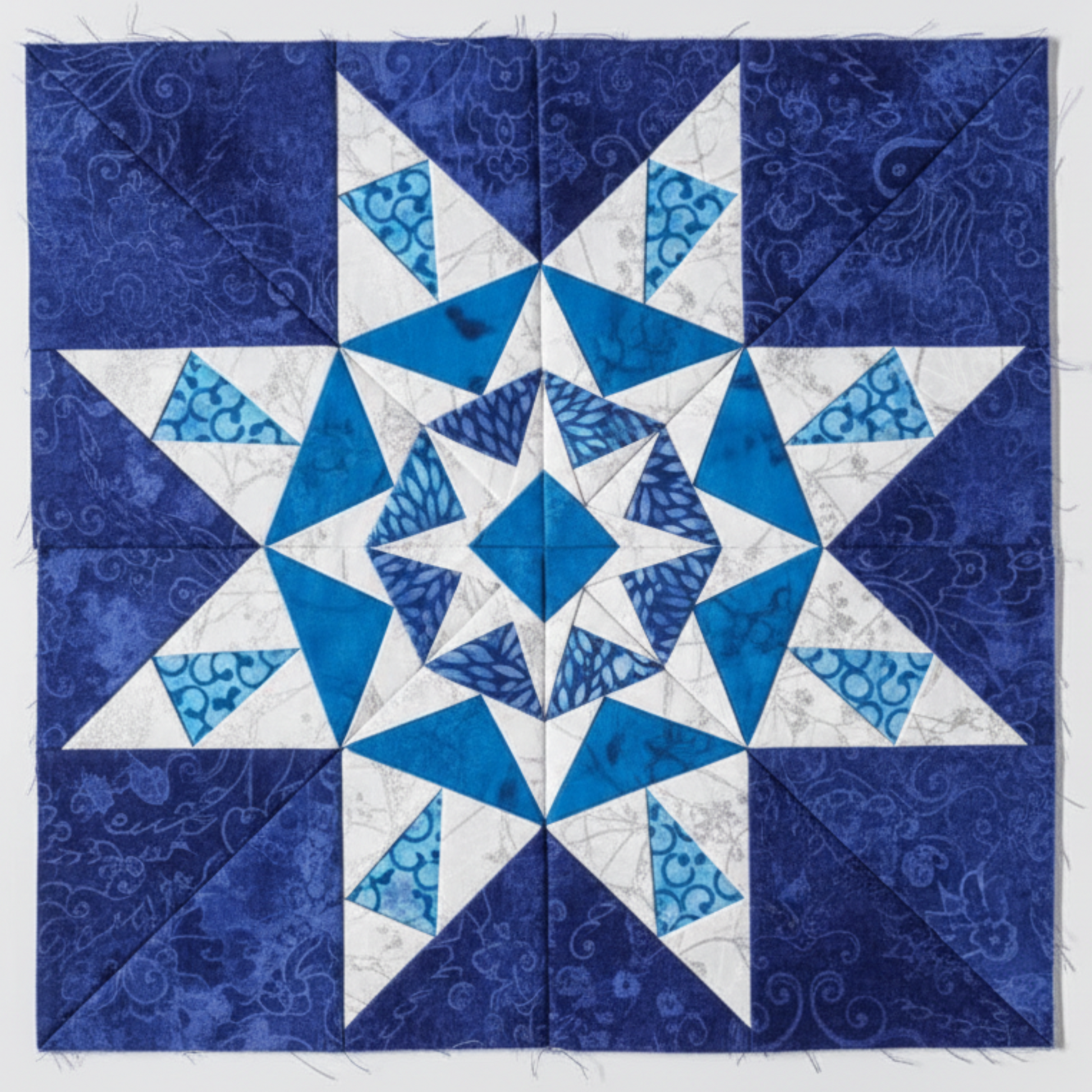 “Paper-pieced star quilt block in blue and white fabrics from 60 Fabulous Paper-Pieced Stars Second Edition”
