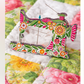 Decorative Superbloom sewing machine needle minder on a floral quilt, featuring Robin Pickens floral design