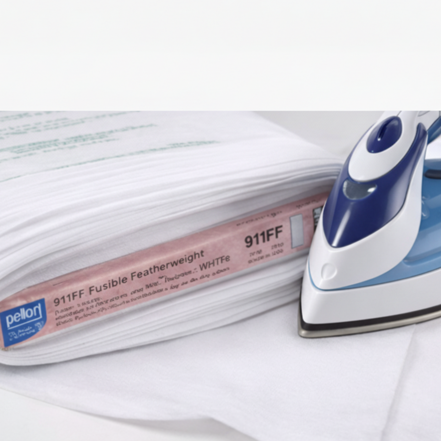 Iron and Pellon fusible web on a white background