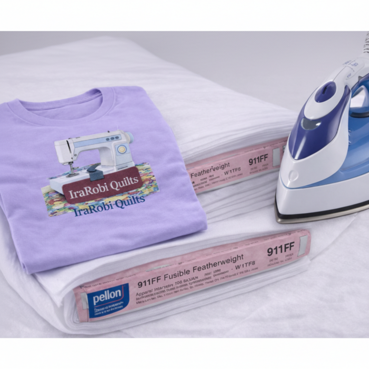 Purple t-shirt with a sewing machine design, iron, and Pellon fusible web on a white surface