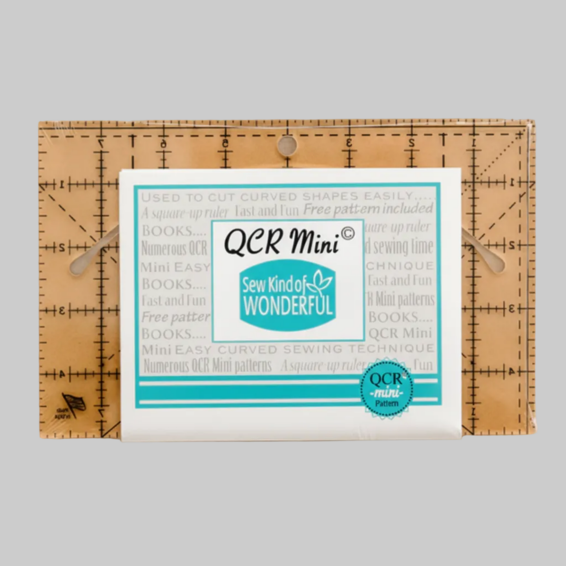 QCR Mini curved quilting ruler displayed in its packaging on a light gray background, highlighting the compact 5″ × 8″ ruler size and Sew Kind of Wonderful branding.