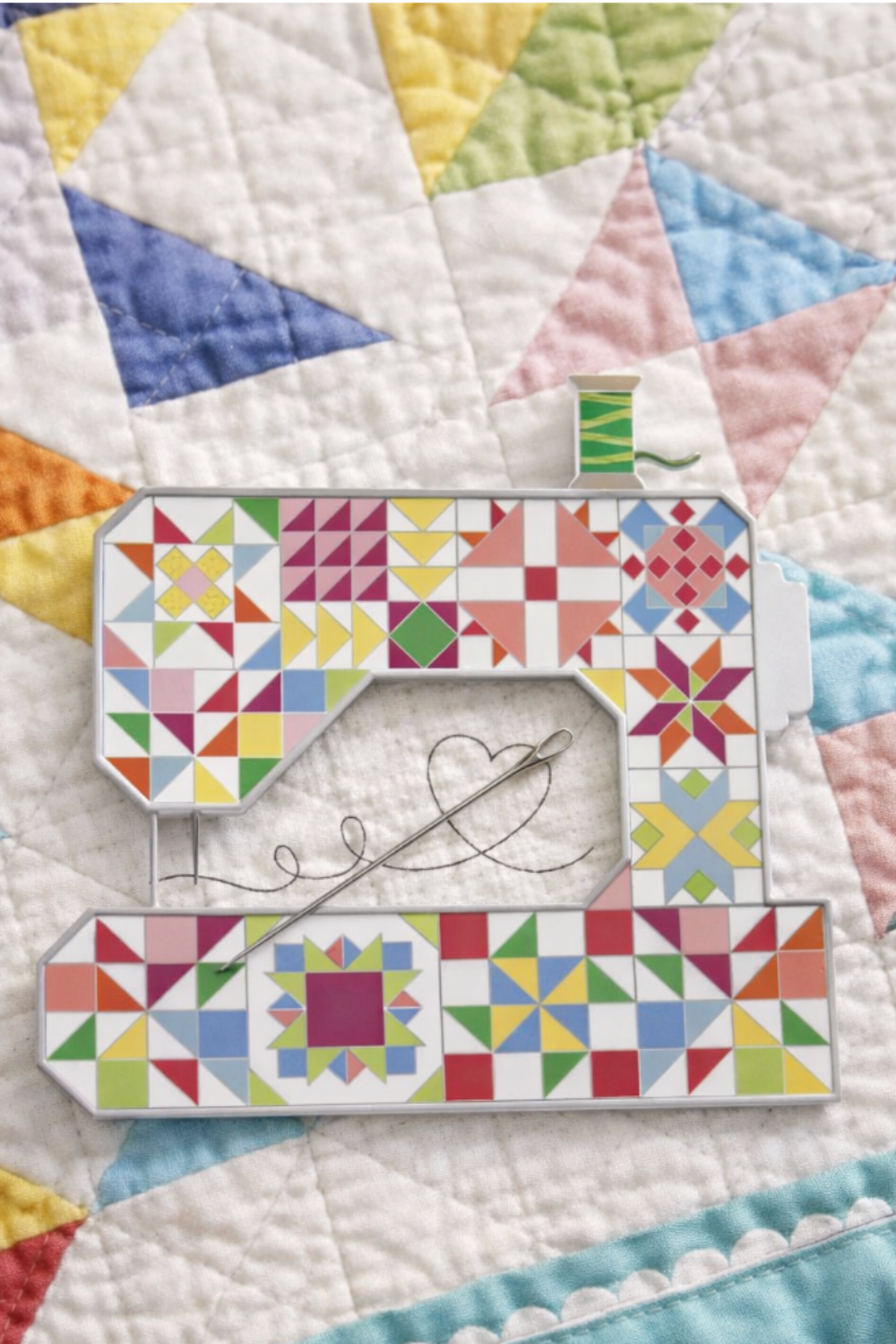 Quilted sewing machine needle minder by Riley Blake Designs on handmade quilt background