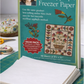 Book titled 'Kim Diehl's Best Appliqué Freezer Paper' on a green cutting mat with appliqué materials.