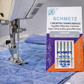 Sewing machine needle with Schmetz Microtex Chrome needles packaging on a blue quilted fabric background