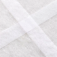 Fusible seam batting tape joining two batting pieces at cross seam detail close-up