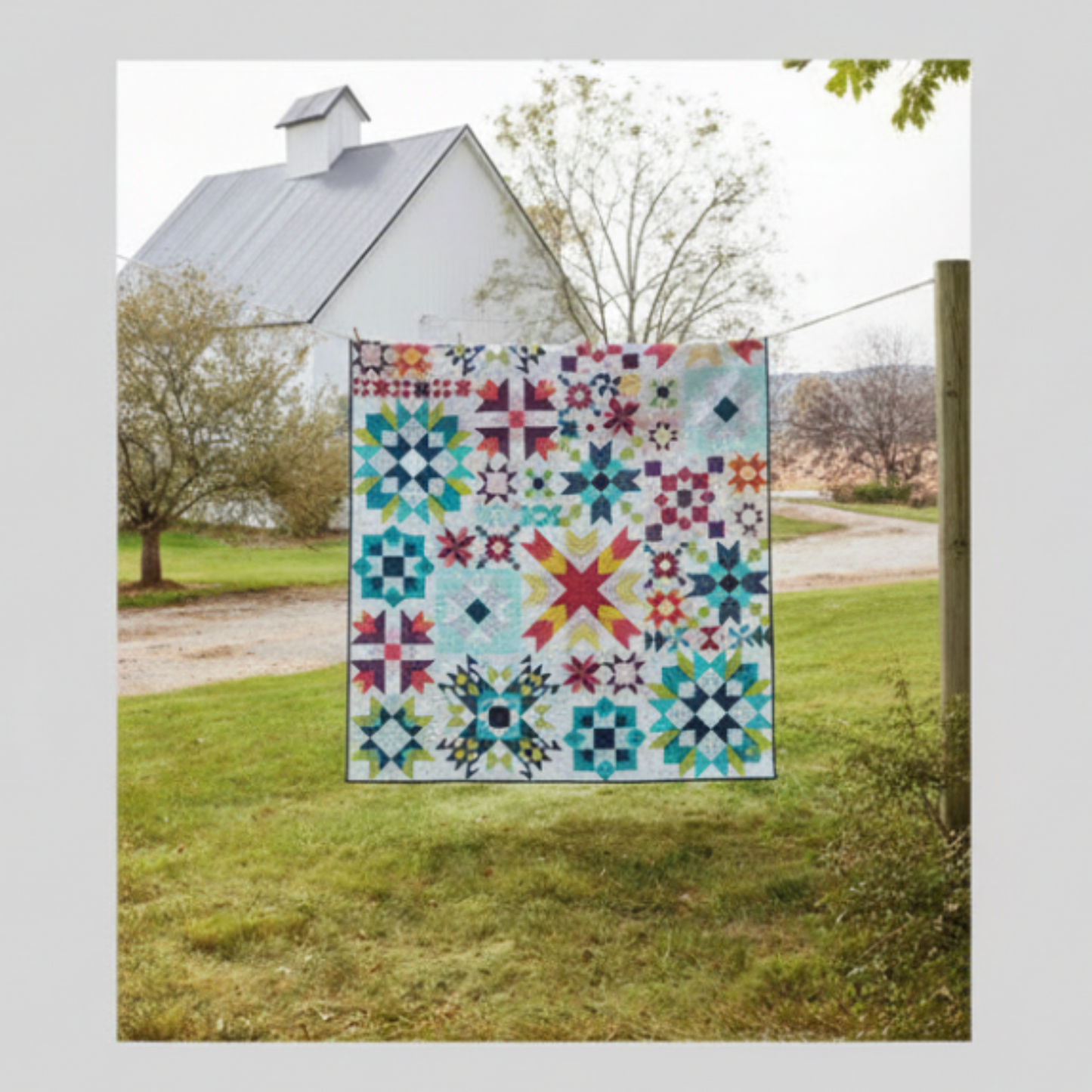 Barn star sampler quilt – colorful star quilt hanging outdoors on barn clothesline