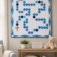 Rosary Baby Quilt wall hanging displayed in peaceful nursery with soft neutral décor, teddy bear, and inspirational Christian accents