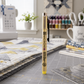 Yellow Pigma Micron 08 fabric marking pen standing on a quilting cutting mat in a bright sewing room with folded quilts, quilting ruler, thread spools, and sewing machine.