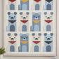 Handmade puppy quilt with twelve blue geometric dog blocks and colorful bandanas displayed as a wall hanging, featuring detailed quilting and a soft blue border.