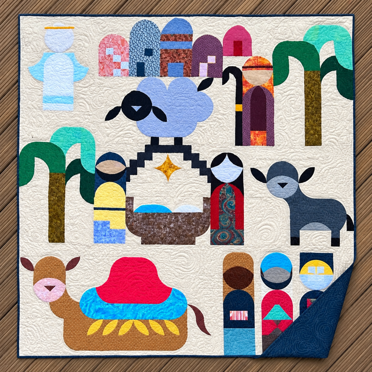 Starry Night nativity quilt with the lower-right corner folded back to reveal dark blue backing and spiral quilting.