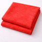 Expressions Batiks Hand-Dyes Tomato Red fabric by Riley Blake Designs folded in two neat stacked pieces on a white surface – bold vivid tomato red tonal hand-dyed batik with subtle lighter rose highlights and deeper crimson organic mottled variation, a striking warm focal blender perfect for warm-toned, patriotic, and holiday quilts, 100% cotton batik
