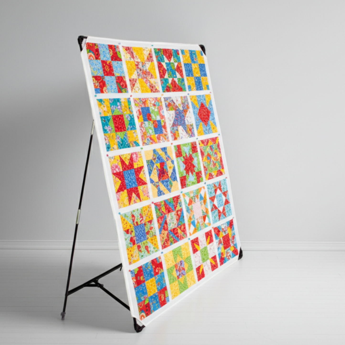 Quilt design wall in sewing room with fabric blocks displayed