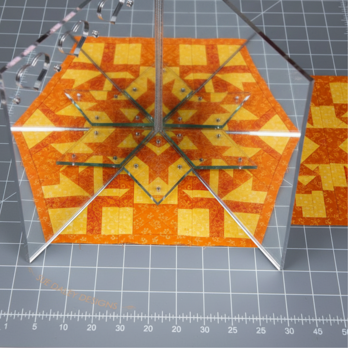 Sue Daley fussy cutting mirror creating kaleidoscope effect on floral quilting fabric for precise fussy cutting