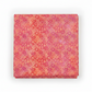 Allure Orange Shadow Flowers quilting cotton fabric folded to show allover tonal shadow floral – silhouetted daisies, stems, and berry sprigs in vibrant coral, orange, red, magenta, and pink watercolor wash by Jason Yenter for In The Beginning Fabrics, 100% cotton, 3 yard cut