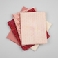 Allure Peach Lattice quilting cotton fabric by Jason Yenter for In The Beginning Fabrics shown in a coordinate stack with Allure Red Lanterns and coordinating soft pink and peach quilting fabrics – soft tonal geometric lattice in blush pink, peach, and cream, 100% cotton, 3 yard cut