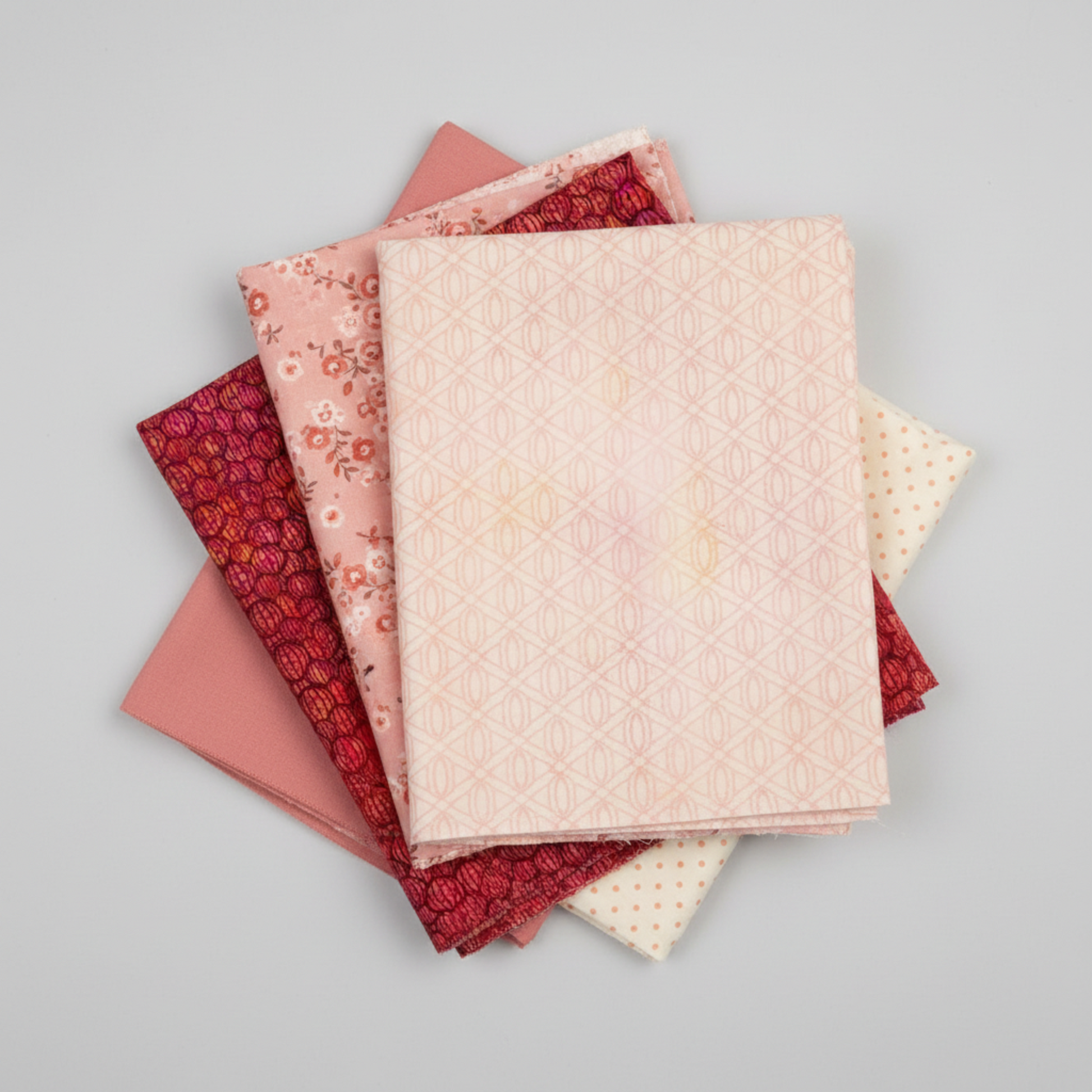 Allure Peach Lattice quilting cotton fabric by Jason Yenter for In The Beginning Fabrics shown in a coordinate stack with Allure Red Lanterns and coordinating soft pink and peach quilting fabrics – soft tonal geometric lattice in blush pink, peach, and cream, 100% cotton, 3 yard cut