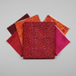Allure Red Lanterns quilting cotton fabric by Jason Yenter for In The Beginning Fabrics shown in a coordinate stack with complementary warm-toned quilting fabrics in deep burgundy, crimson, magenta, and orange – allover striped oval lantern pattern, 100% cotton, 3 yard cut
