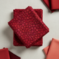 Allure Red Lanterns fabric by Jason Yenter for In The Beginning Fabrics stacked on a light linen surface with coordinating warm red and coral fabrics – allover striped oval lantern pattern in rich crimson, ruby, magenta, and orange, perfect for bold warm-toned quilt projects, 100% cotton, 3 yard cut