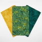 Three coordinating Expressions Batiks Hand-Dyes fabrics by Riley Blake Designs in a fan arrangement – Amazon in rich jungle green with golden-yellow undertones at center, flanked by Curry in warm golden-yellow and Evergreen in deep teal-green tonal batiks – 100% cotton