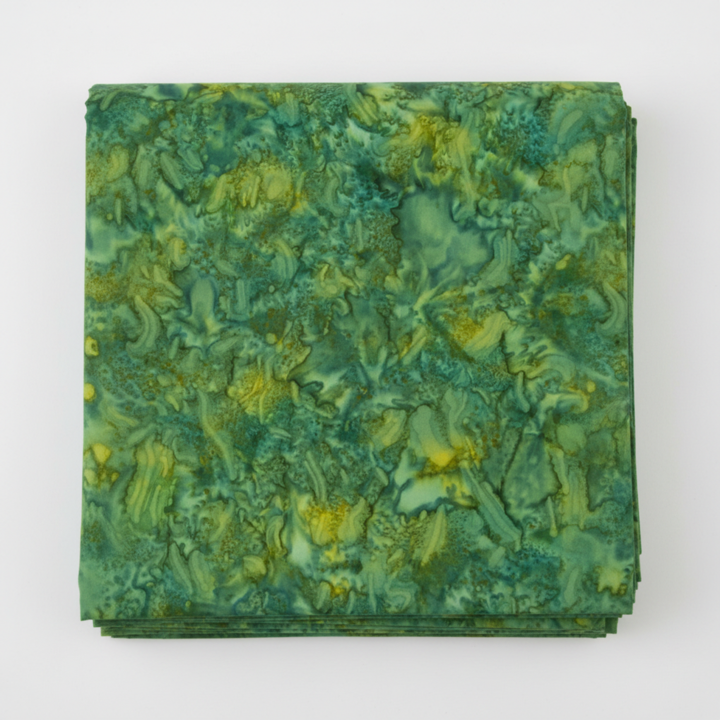 Expressions Batiks Hand-Dyes Amazon quilting cotton fabric by Riley Blake Designs folded into a neat square showing rich jungle green hand-dyed batik with warm golden-yellow undertones and organic swirling mottled texture – a vibrant tonal blender, 100% cotton batik, 43–44" wide