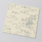Angled swatch of Eggshell Edgy fabric by Zen Chic for Moda Fabrics on a light gray background, showing its subtle gray geometric print.