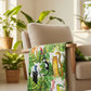 Safari Fun White/Multi quilting cotton draped over a natural linen armchair in a bright room with tropical plants — large-scale watercolor jungle animal print by Terry Runyan for Benartex | IraRobi Quilts
