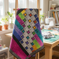 Interwoven Hot Pink Fabric by Jason Yenter for In The Beginning Fabrics as a vivid hot pink strip in an Aurora Nights quilt — rainbow Interwoven crosshatch tonals with star blocks on silver-gray and black background. Quilts shown for inspiration feature the Aurora Nights Quilt Pattern by Bound to Be Quilting — available at IraRobi Quilts.