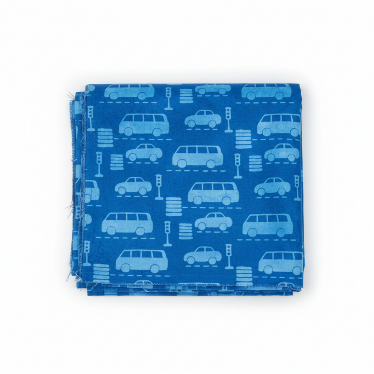 On the Go Automobiles Blue quilting cotton by Jason Yenter for In The Beginning Fabrics — folded yardage on a white surface showing tone-on-tone automobile silhouettes with traffic lights and crosswalk stripes on a deep cobalt-blue ground, 100% cotton, 43–44" wide.