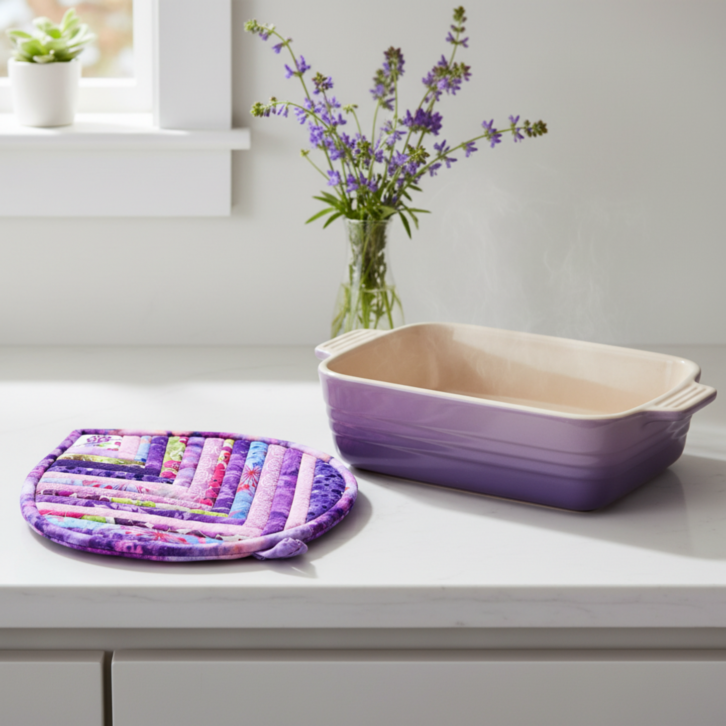 Leaf-Shaped Quilted Hot Pad – Violet Bloom beside a lavender ceramic baking dish | Handmade kitchen gift from IraRobi Quilts"