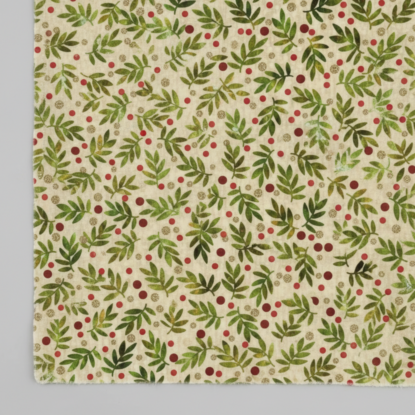 Winter Solstice II Beige Twigs Metallic quilting cotton by Jason Yenter for In The Beginning Fabrics — close-up flat lay showing tossed watercolor green fern sprigs with scattered red berry dots and tiny gold metallic berry clusters on warm beige and cream ground, 100% cotton with metallic accents, 43–44" wide. Coordinating fabrics and quilt patterns are available at IraRobi Quilts.