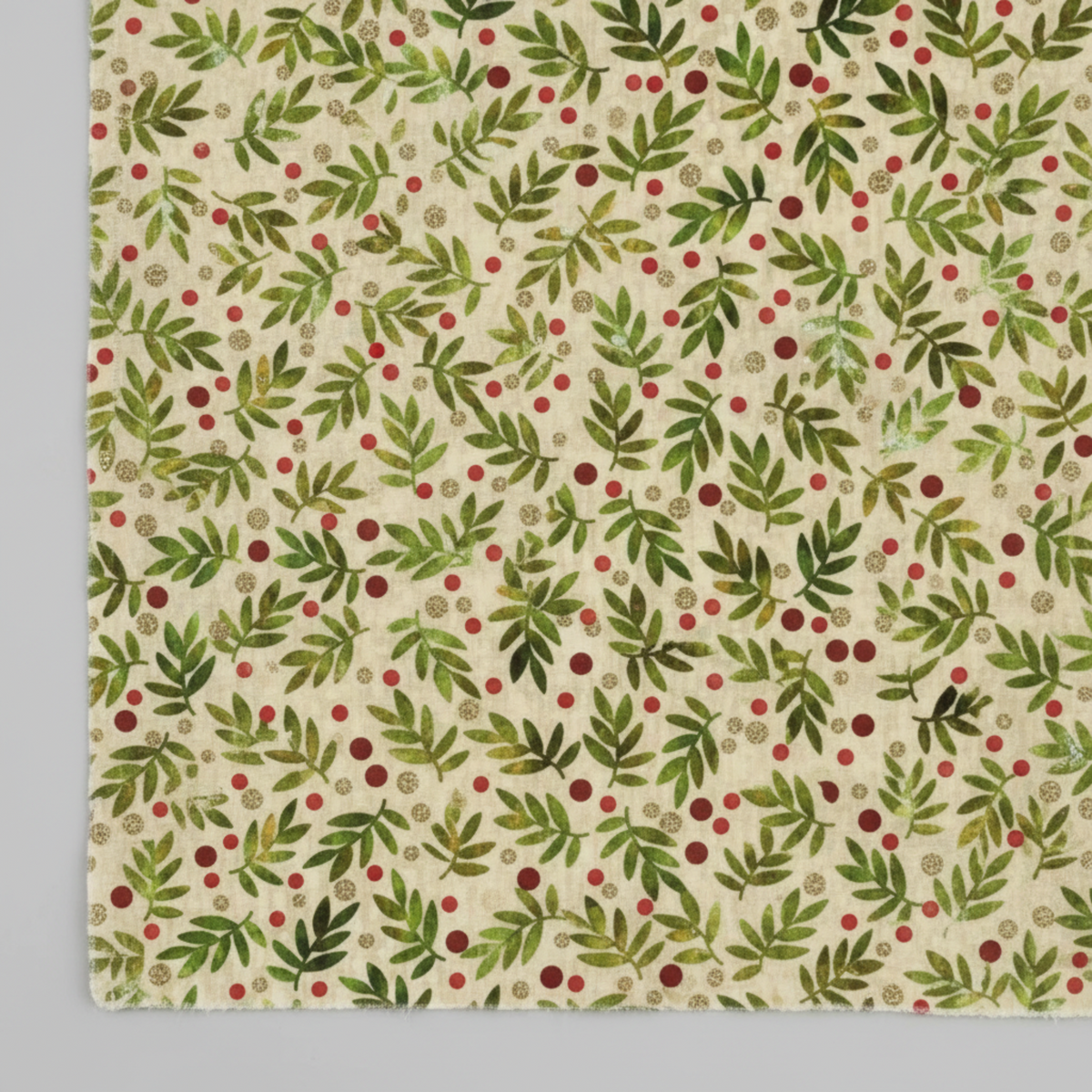 Winter Solstice II Beige Twigs Metallic quilting cotton by Jason Yenter for In The Beginning Fabrics — close-up flat lay showing tossed watercolor green fern sprigs with scattered red berry dots and tiny gold metallic berry clusters on warm beige and cream ground, 100% cotton with metallic accents, 43–44" wide. Coordinating fabrics and quilt patterns are available at IraRobi Quilts.