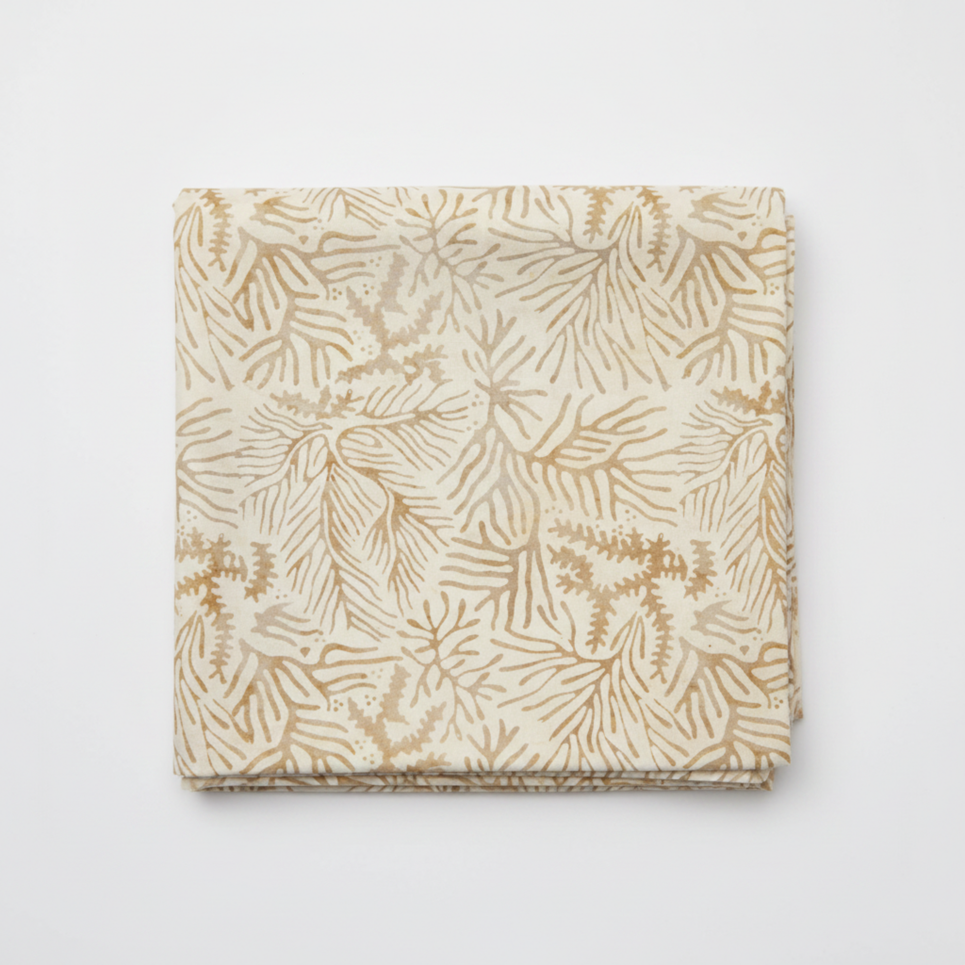 Expressions Batiks Breathe Ecru quilting cotton fabric by Riley Blake Designs folded into a neat square showing warm cream and ecru tonal batik with pine needle and feathery frond motif in soft taupe and golden-beige – a refined neutral blender, 100% cotton batik, 43–44" wide