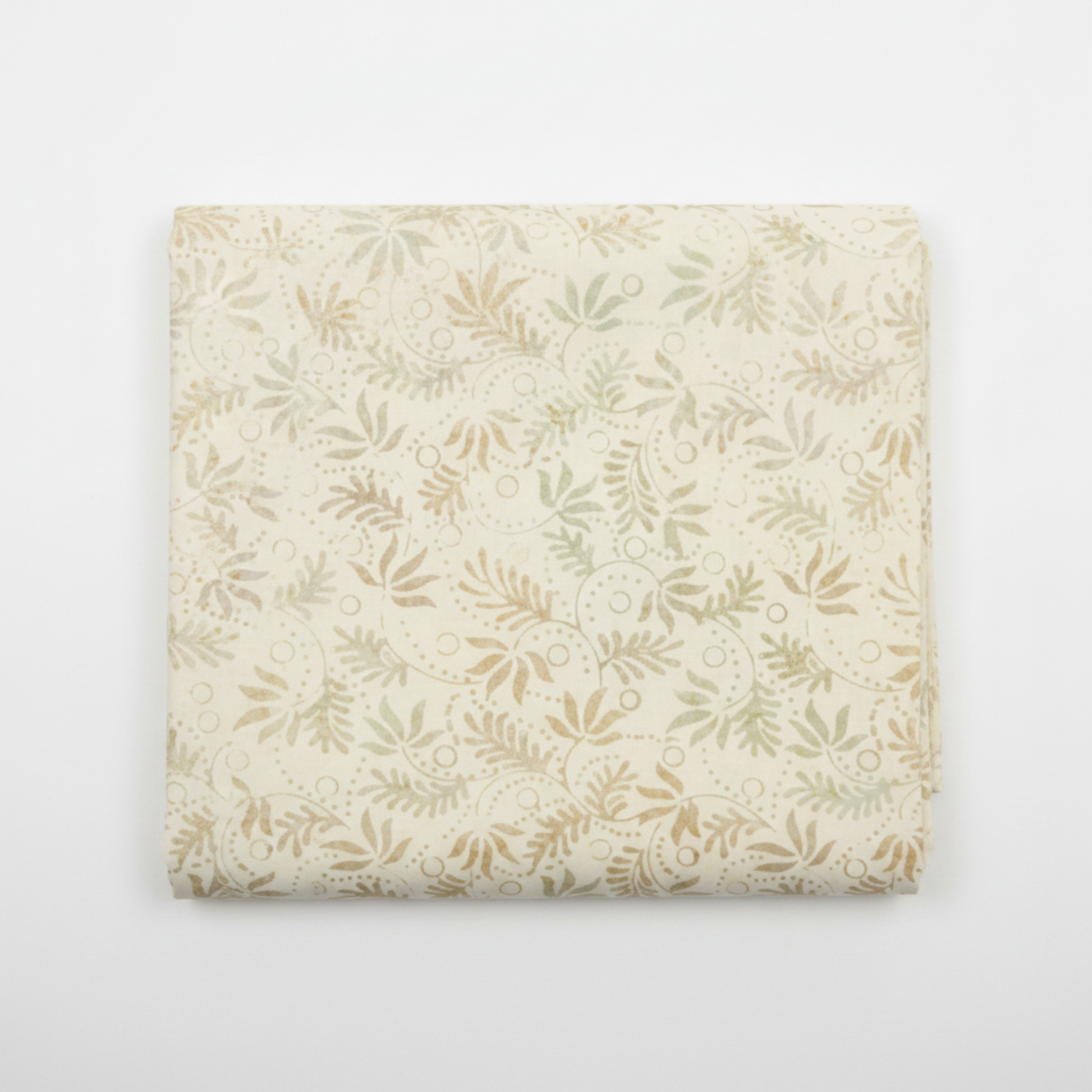Expressions Batiks Breathe Laurel quilting cotton fabric by Riley Blake Designs folded into a neat square showing cream and ivory tonal batik with feathery fronds, dotted swirl outlines, and leaf sprigs in soft sage green and warm taupe – a sophisticated botanical blender, 100% cotton batik, 43–44" wide