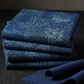 Carpet Bag Romance Blue Brocade fabric by Jason Yenter for In The Beginning Fabrics folded on a dark linen surface – rich tonal patchwork of damask, brocade, scrollwork, and medallion motifs in deep navy and steel blue, perfect for vintage and antique-inspired quilt projects, 100% cotton, 3 yard cut