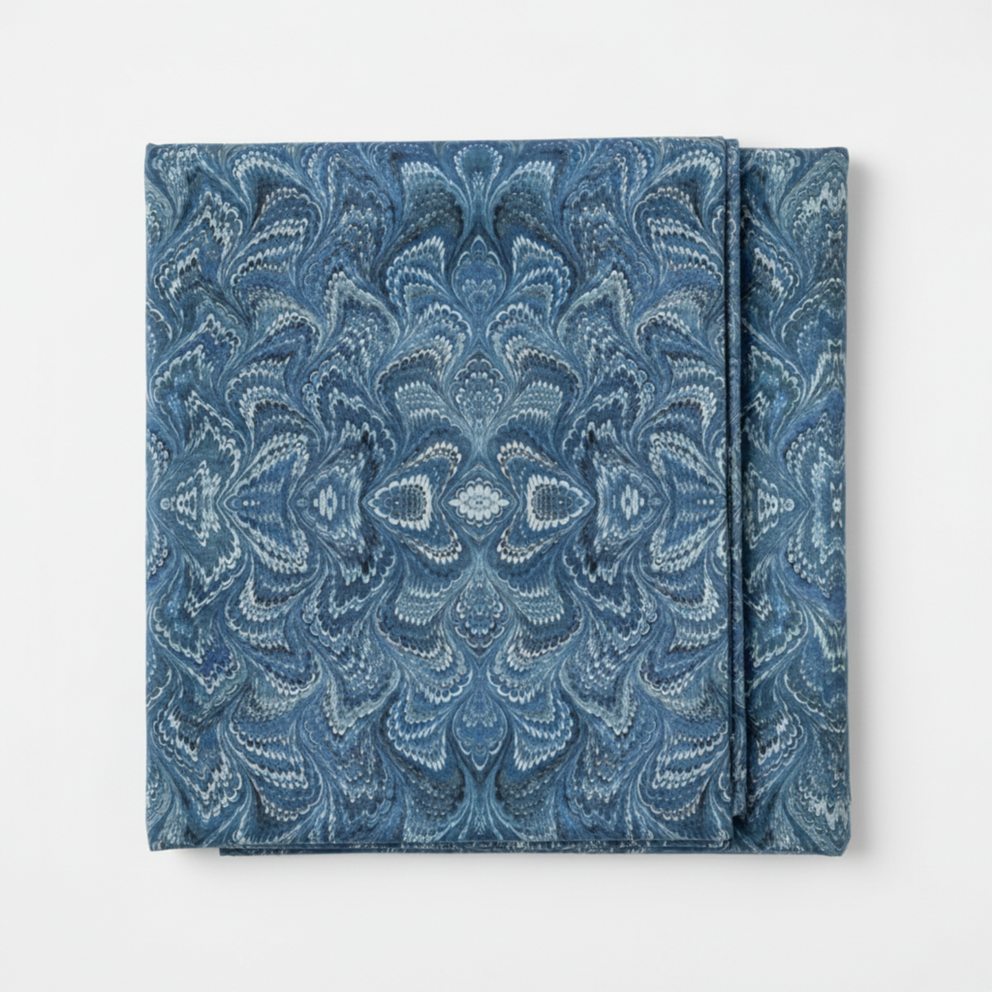 Carpet Bag Romance Blue Marble quilting cotton fabric folded to show intricate symmetrical marbled damask – kaleidoscopic feathered medallion pattern in deep steel blue, slate, and navy with shimmering white highlights by Jason Yenter for In The Beginning Fabrics, 100% cotton, 3 yard cut