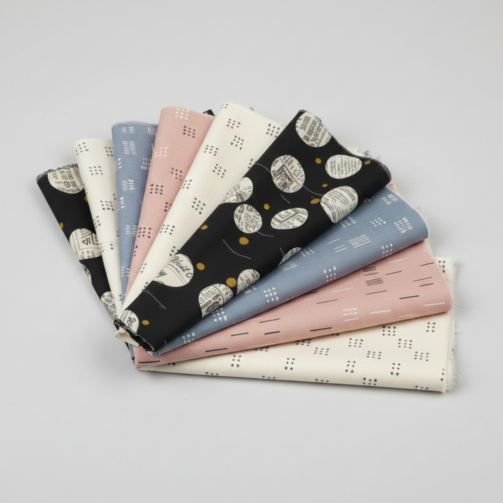 Celestial collection by Zen Chic for Moda Fabrics – full fabric fan showing coordinating prints in black, cream, blue, pink and white on light grey background