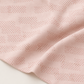 Celestial Washi Rose Quartz fabric arranged in soft folds, showing its pale blush ground and small dotted motifs.
