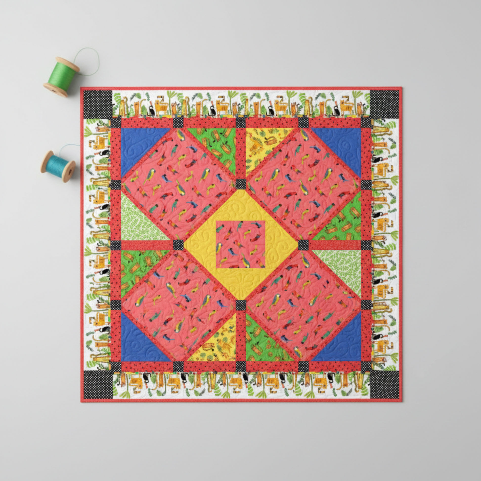 Child's patchwork quilt featuring Safari Fun Jungle Birds Sorbet coral parrot fabric in diamond blocks with coordinating green, yellow, blue, and red fabrics — IraRobi Quilts