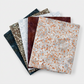 Terrazzo Khaki Fabric by Riley Blake Designs in a five-fabric fan with coordinating fabrics in deep blue, pale gray, raisin, and peach-flecked gray.